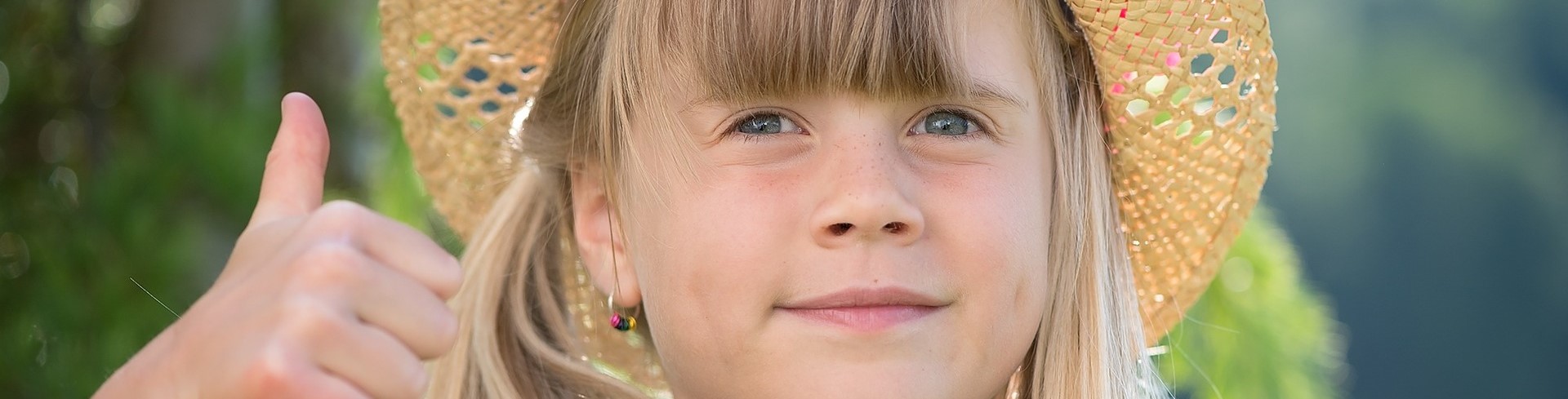 smiling girl showing thumbs up